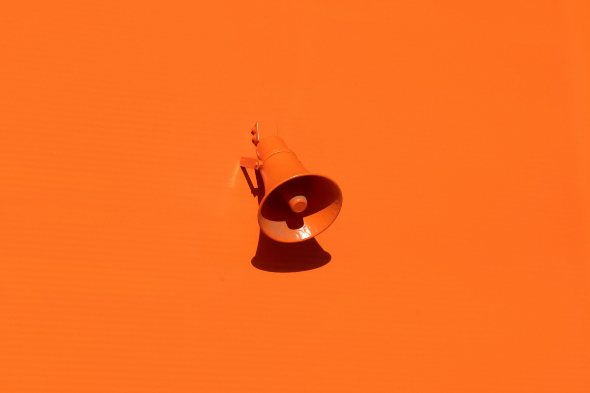News - an orange megaphone against an orange background